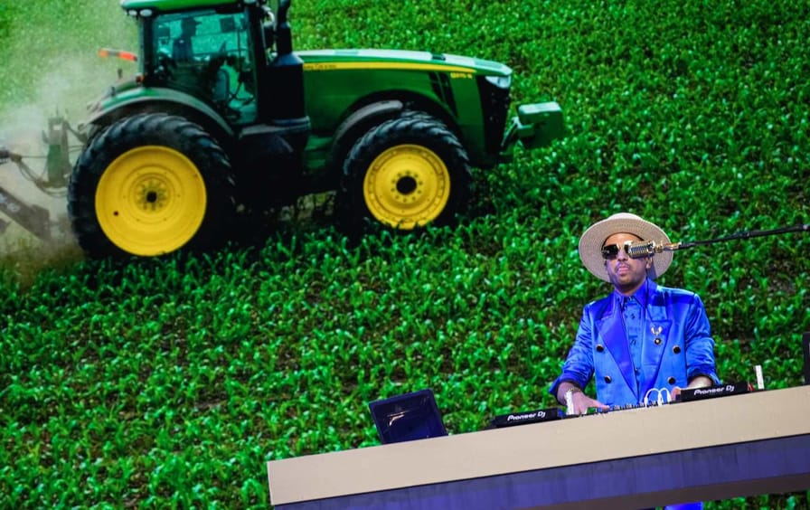 DJ Cassidy performs against a rural-themed backdrop at the 2024 Democratic National Convention in Chicago.