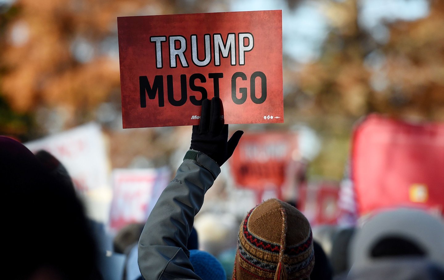 Person holding a sign that reads 