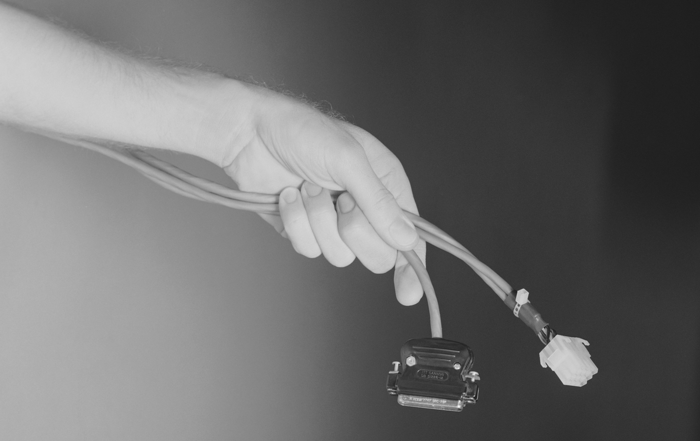 Man holding computer cable, close-up