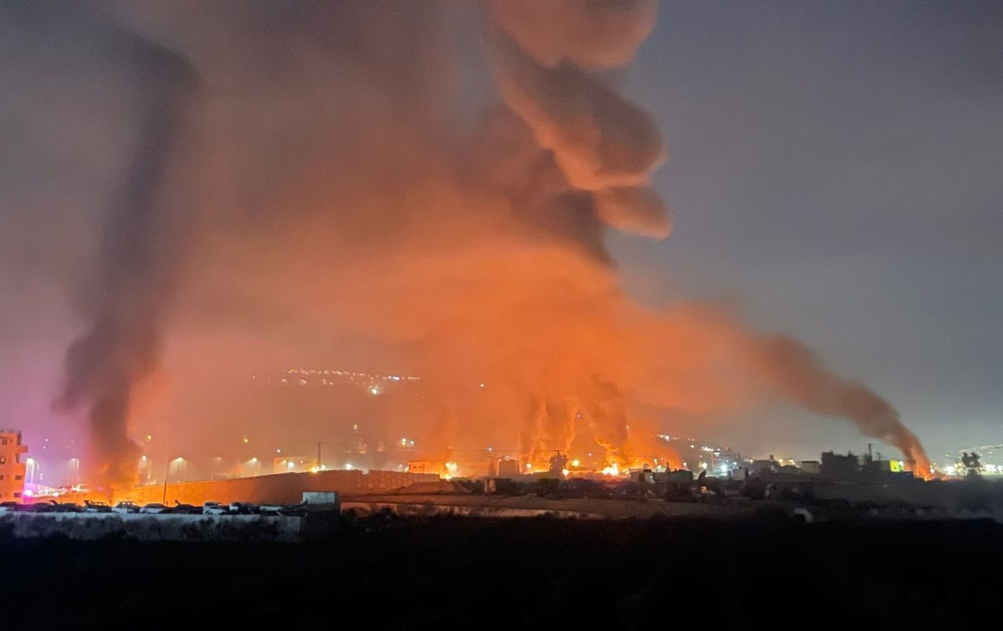Smoke and flames rise after Israeli settlers went on a rampage in the West Bank town of Huwara, setting fire to several homes and cars and injuring dozens of Palestinians, on February 27, 2023.