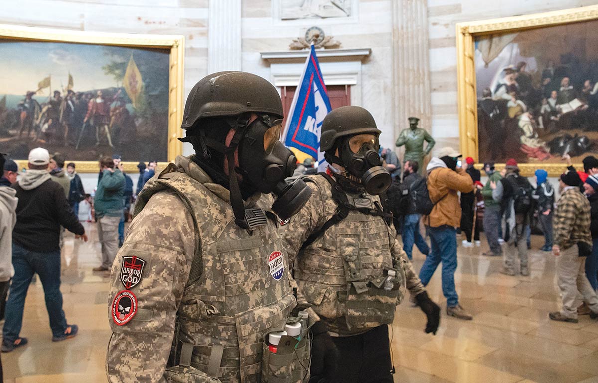 January 6 rioters in military gear at the Capitol Rotunda.