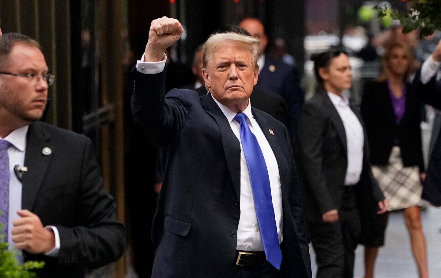 Donald Trump holds his fists outside Trump House after his conviction.