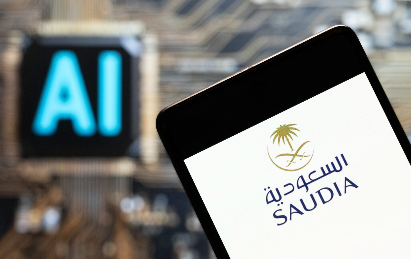 The Saudi Arabian Airlines (Saudia) logo seen displayed on a smartphone with an Artificial intelligence (AI) chip and symbol in the background.