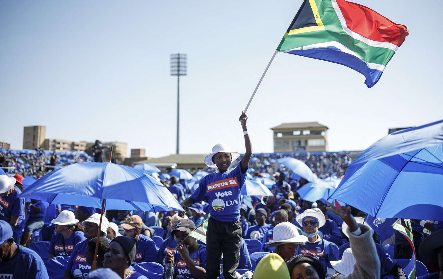 A person waves a South African flag during the DA’s final rally in Benoni on May 26, 2024, ahead of the South African elections scheduled for May 29, 2024.
