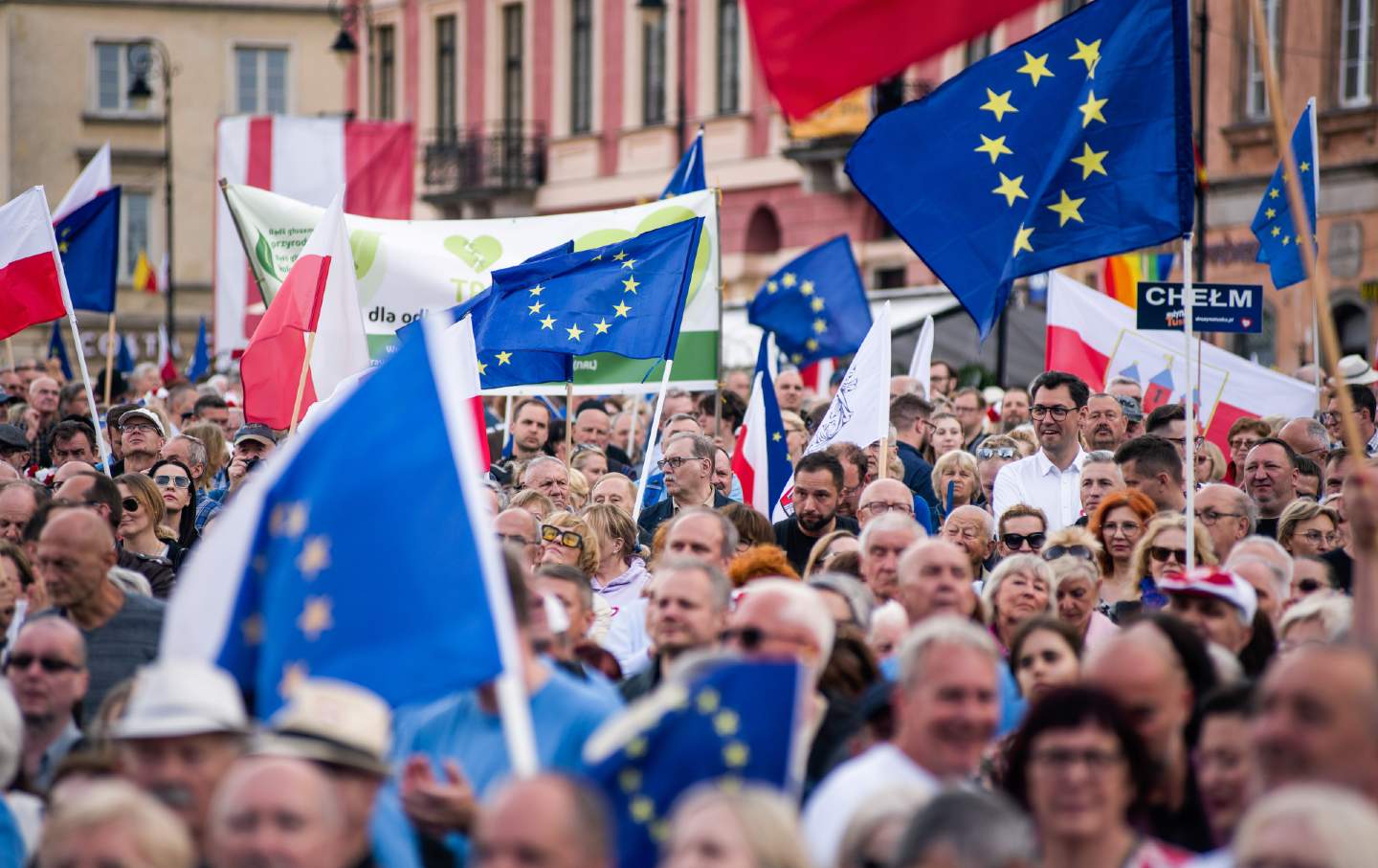 People wave Polish and EU flags during a pro-EU rally organized by Prime Minister Donald Tusk ahead of European Parliament elections in Warsaw's Castle Square on June 4, 2024.