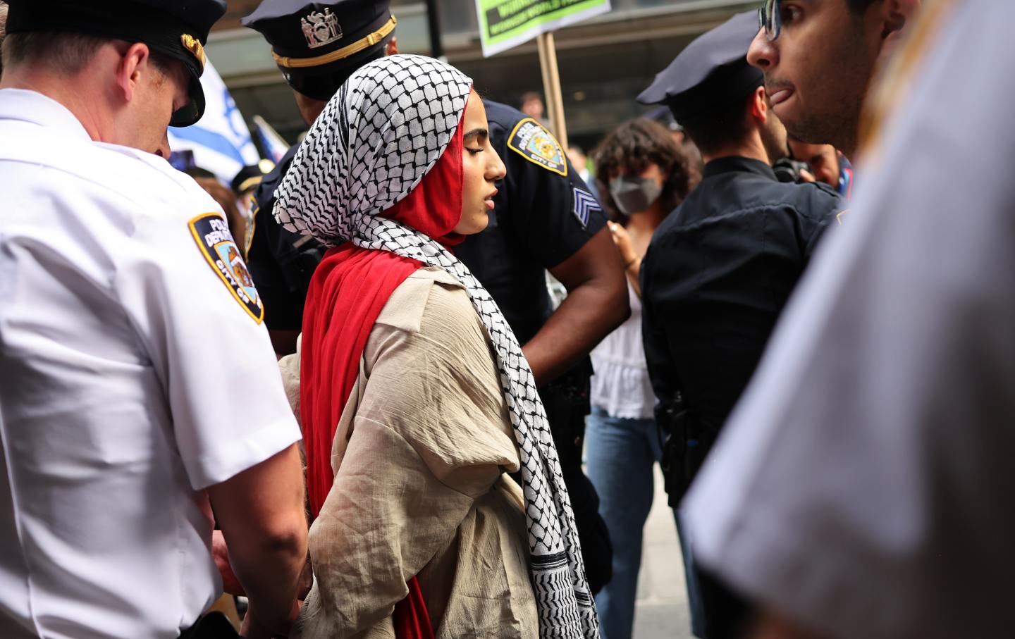 NYPD officers arrest a Pro-Palestine protester during a rally at Baruch College on June 05, 2024 in New York City.