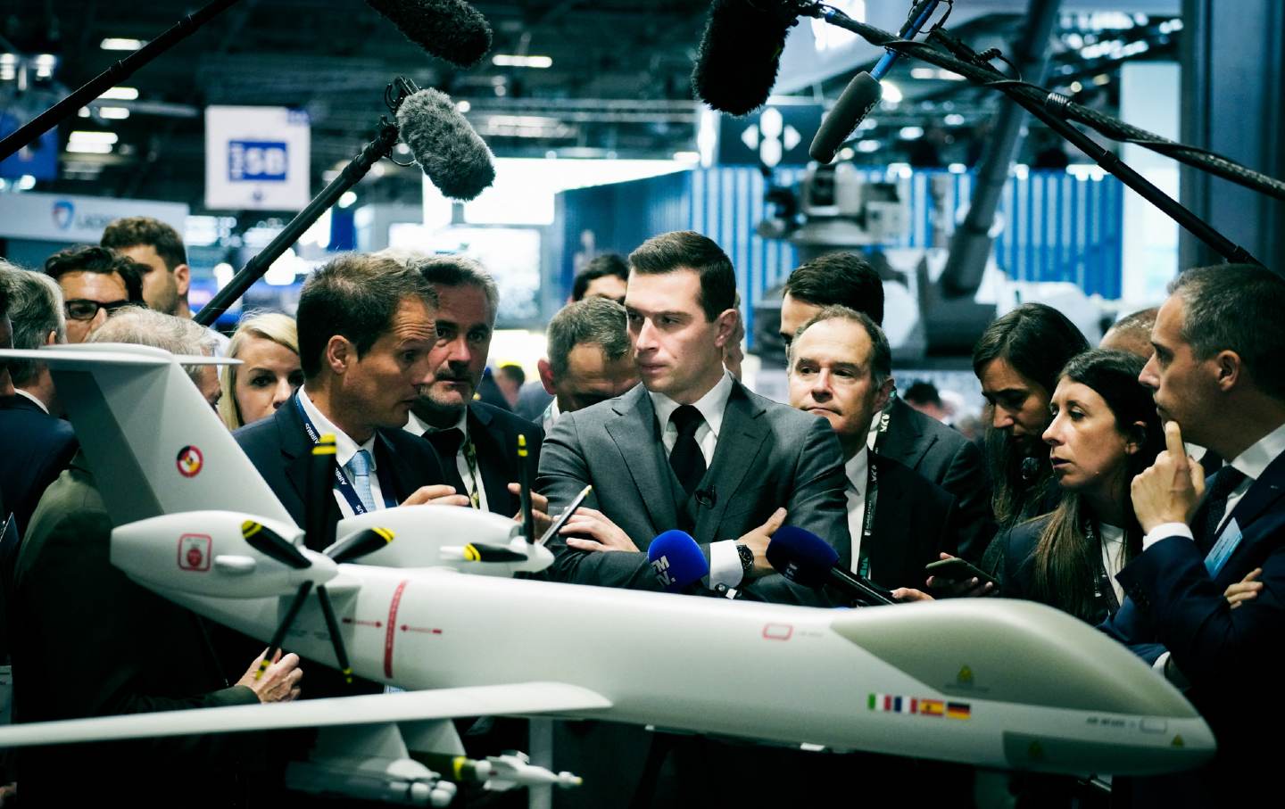 Jordan Bardella, president of the National Rally party, looks at an Airbus military drone model at the Eurosatory international expo in Villepinte, close to Paris, on June 19, 2024.