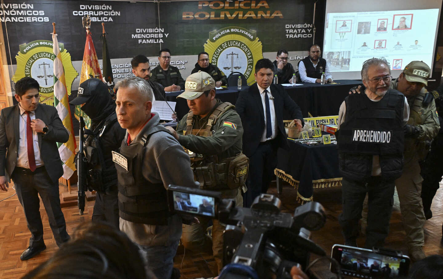 Juan Mario Paulzen Sandy and Anibal Aguilar Gomez are escorted by policemen following their arrest, accused of being accomplices of now-dismissed army chief General Juan Jose Zuniga, after he led a military movement that attempted to seize the government palace by force in La Paz, on June 27, 2024.