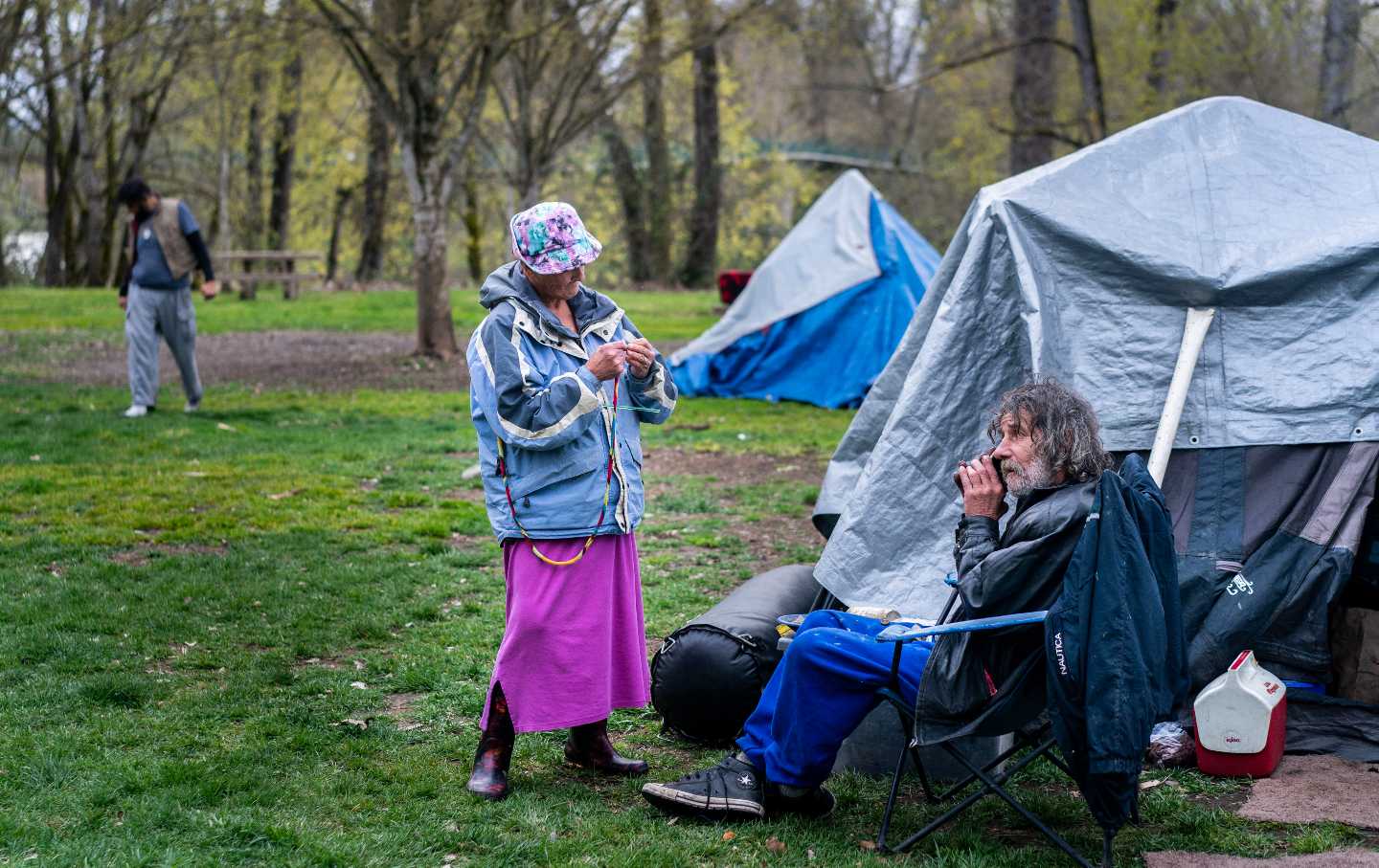 Unhoused senior citizens call a homeless advocate from at Tussing Park in Grants Pass, Oregon. on Thursday. March 28, 2024.