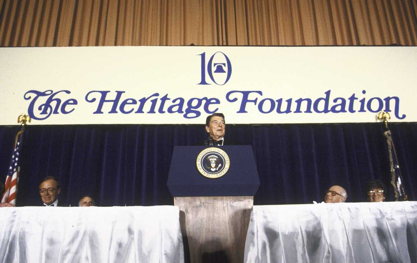 US President Ronald Reagan (C) addresses a Heritage Foundation fete with foundation President Edwin J. Feulner Jr. (L).