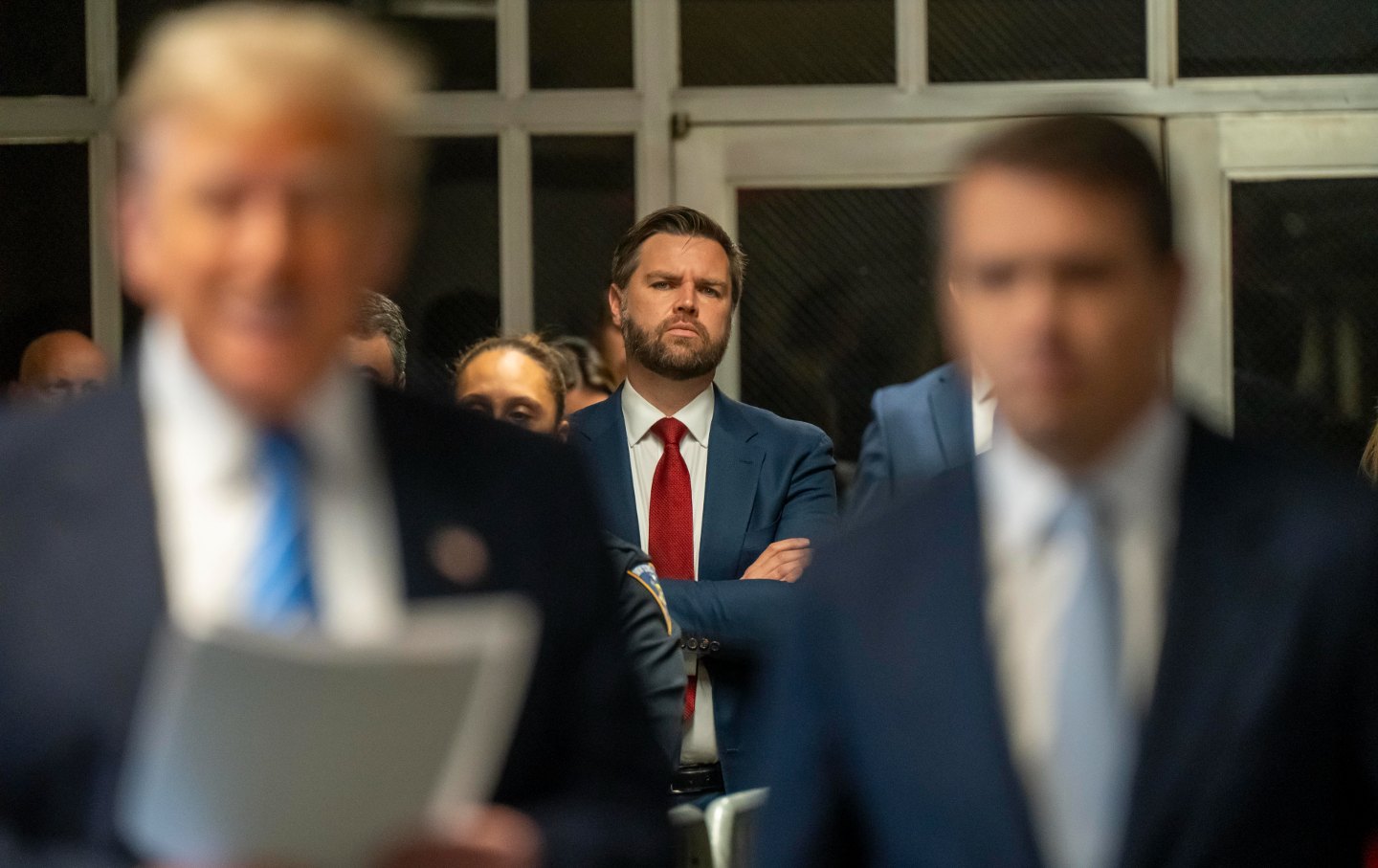 JD Vance in the background in focus with Donald Trump in the foreground out of focus.