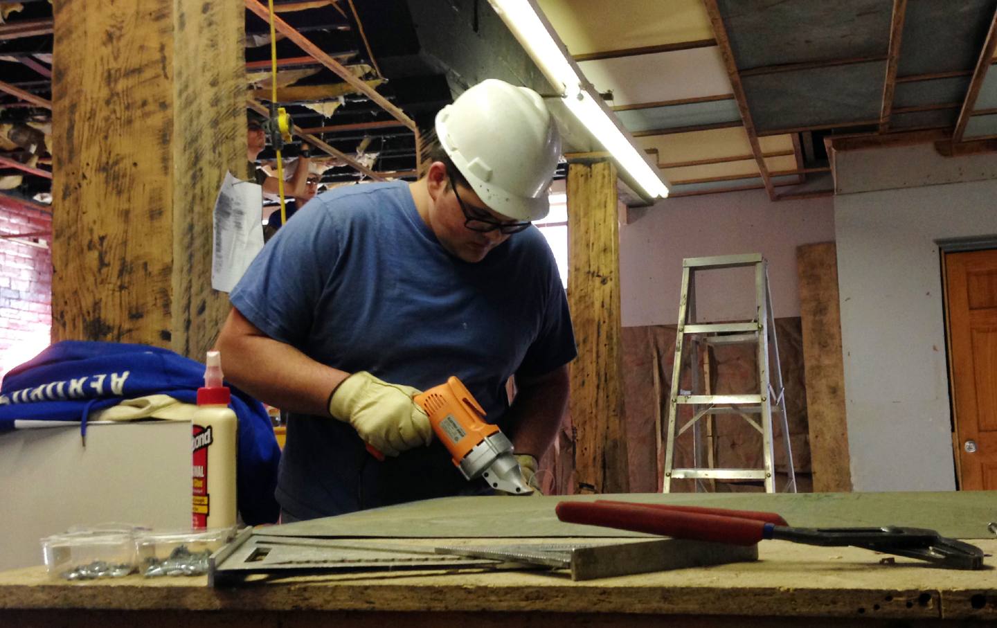 Nathaniel Blankenship, a crew member in a job program with Coalfield Development Corporation, works to remodel a 1920s-era warehouse into office space in Williamson, West Virginia.
