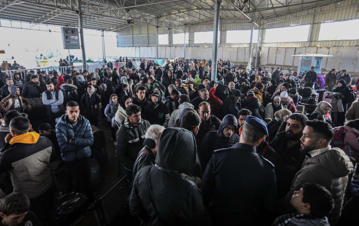 Palestinians prepare to cross to Egypt from the Gaza Strip through the Rafah border crossing on February 6, 2024.