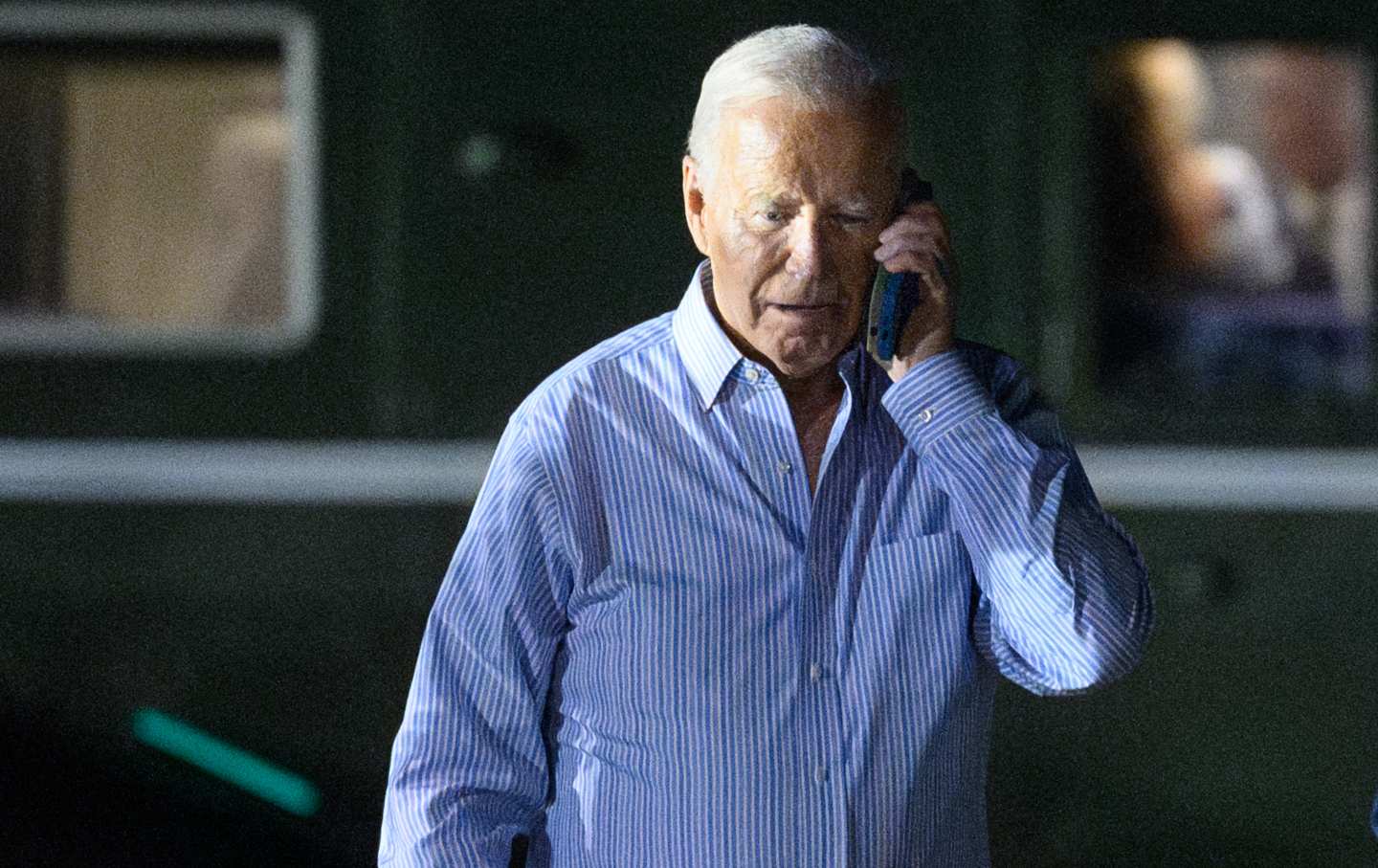 Joe Biden speaks on the phone while walking from Marine One to board Air Force One before departing McGuire Air Force Base in New Jersey on June 29, 2024.