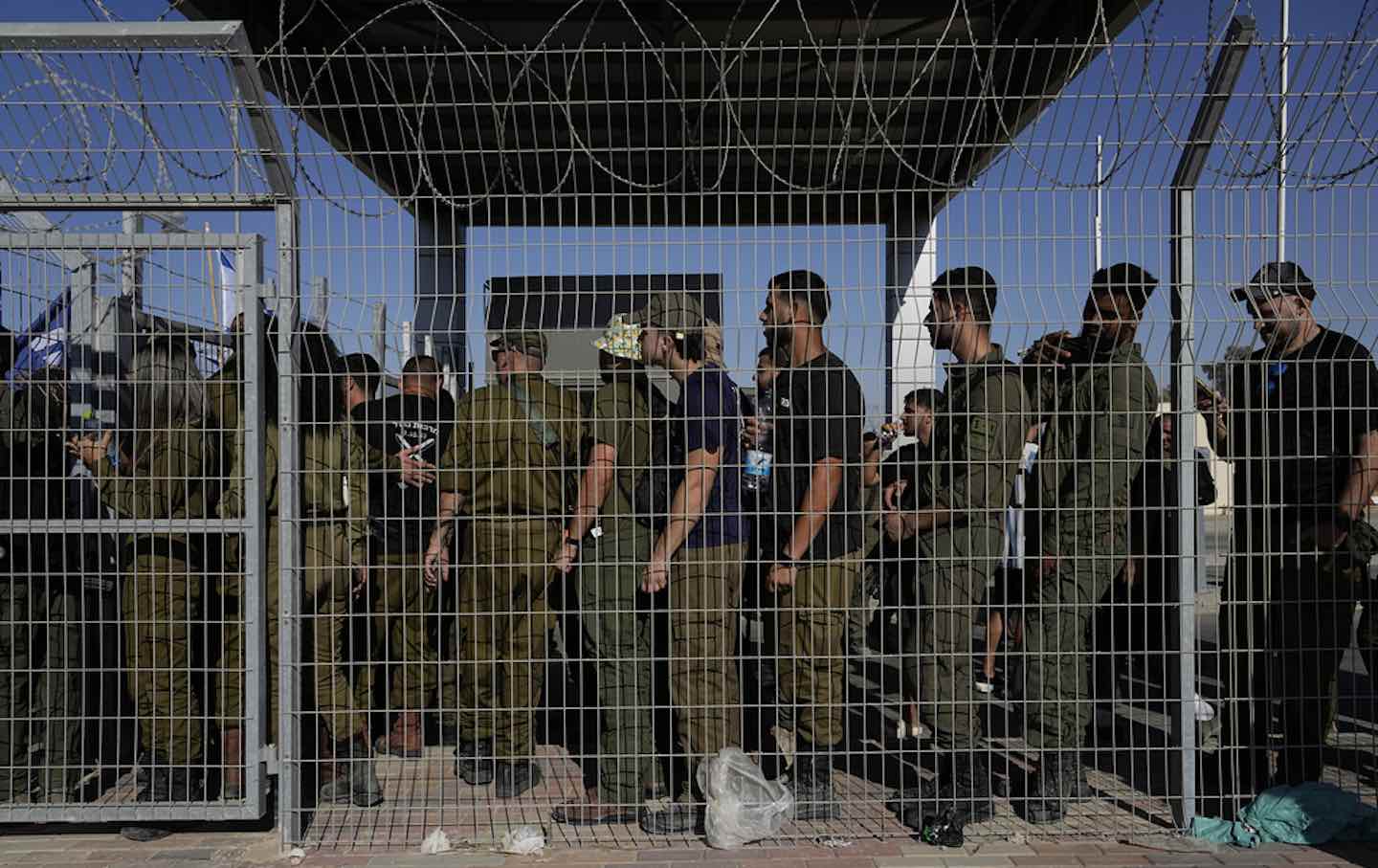 Israeli soldiers gather at the gate to the Sde Teiman military base on July 29, 2024.