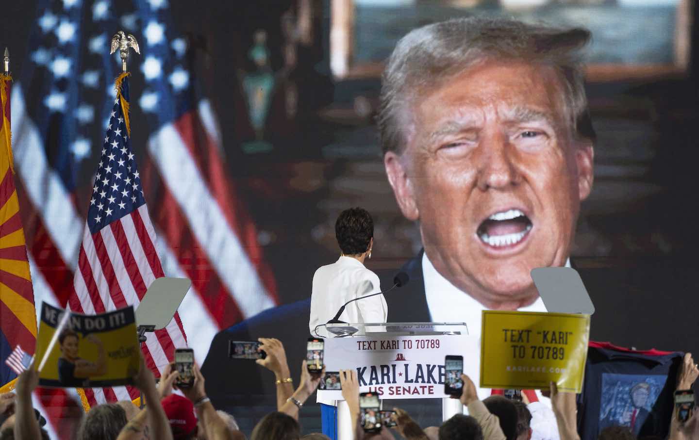 Former Republican gubernatorial candidate Kari Lake watches a prerecorded video of former president Donald Trump giving Lake his endorsement in the race for the seat of Senator Kyrsten Sinema (I-AZ) on October 10, 2023, at the offices of “JetSet Magazine” in Scottsdale, Arizona.