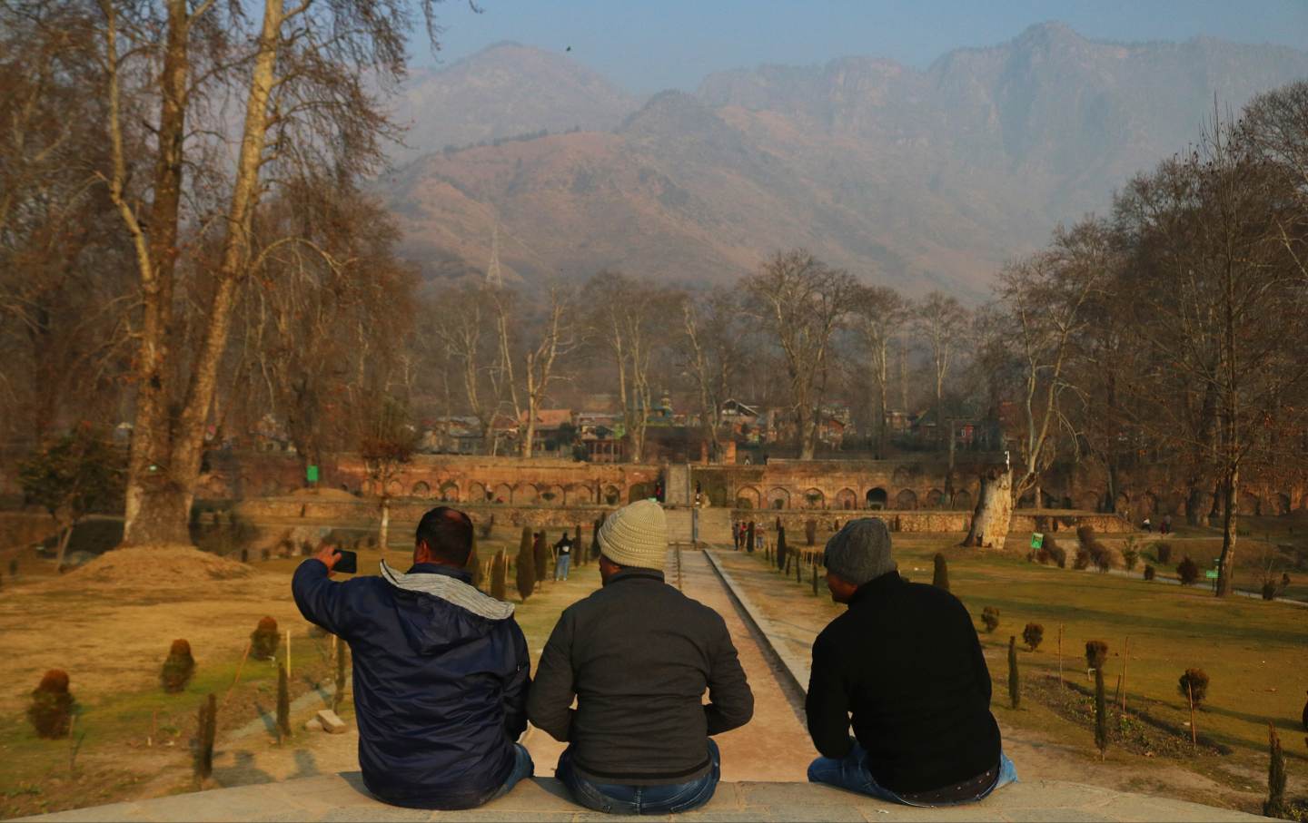 Tourists take selfie photos at Nishat Garden in Srinagar