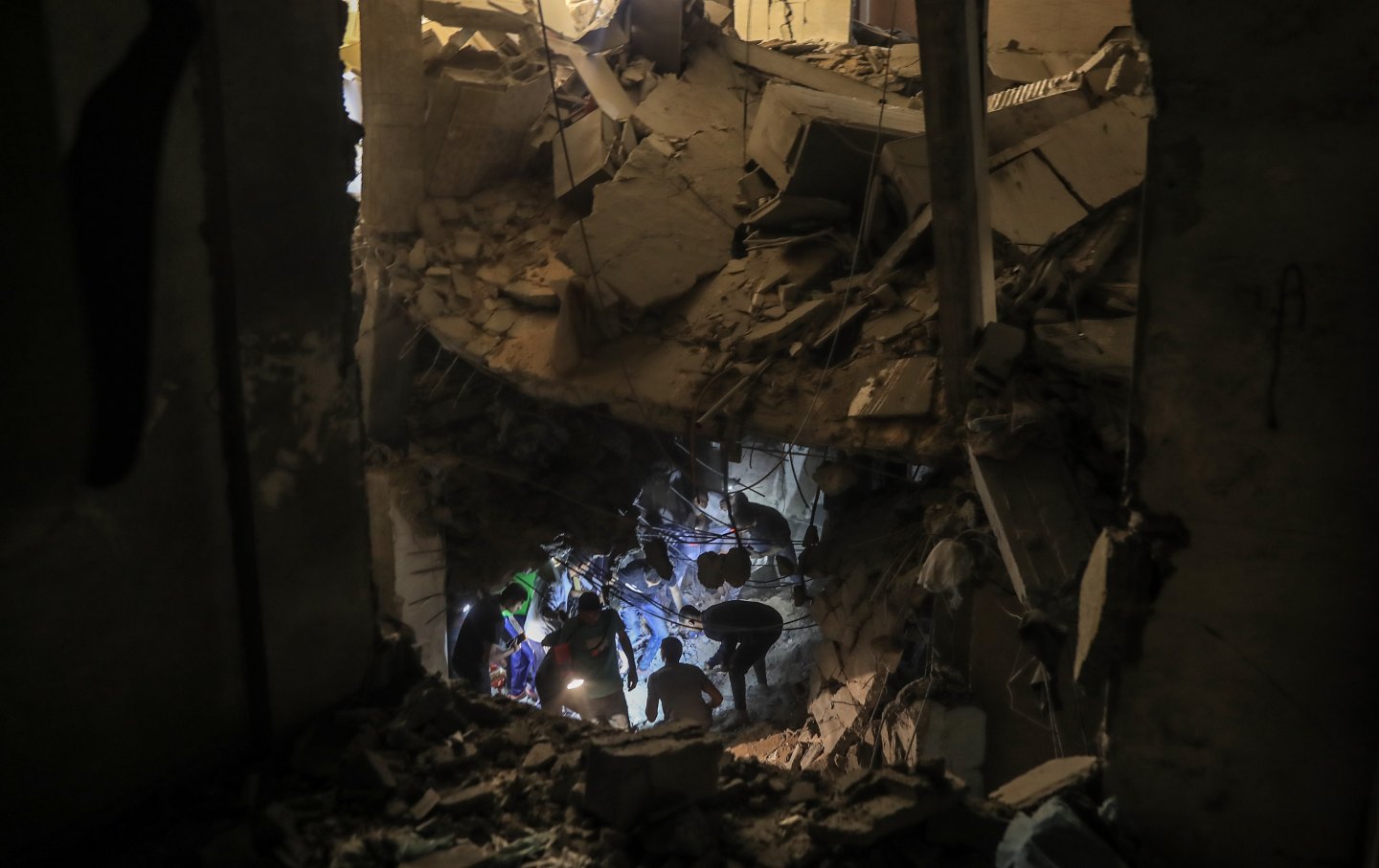 Locals carry out search and rescue efforts after an Israeli attack on the Ridwan family home in Rafah, Gaza, on April 20, 2024.