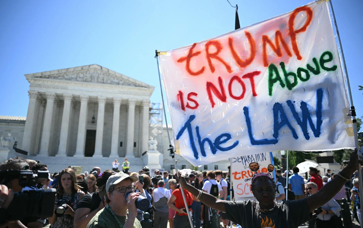 Protesters gather outside the Supreme Court Building on July 1, 2024, the day the court issued its decision in Donald Trump's immunity case.