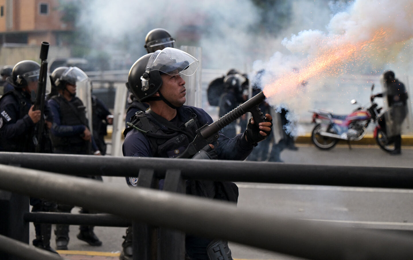 A police officer fires tear gas during a protest against President Nicolas Maduro's government in Caracas, on July 29, 2024, a day after the Venezuelan presidential election.