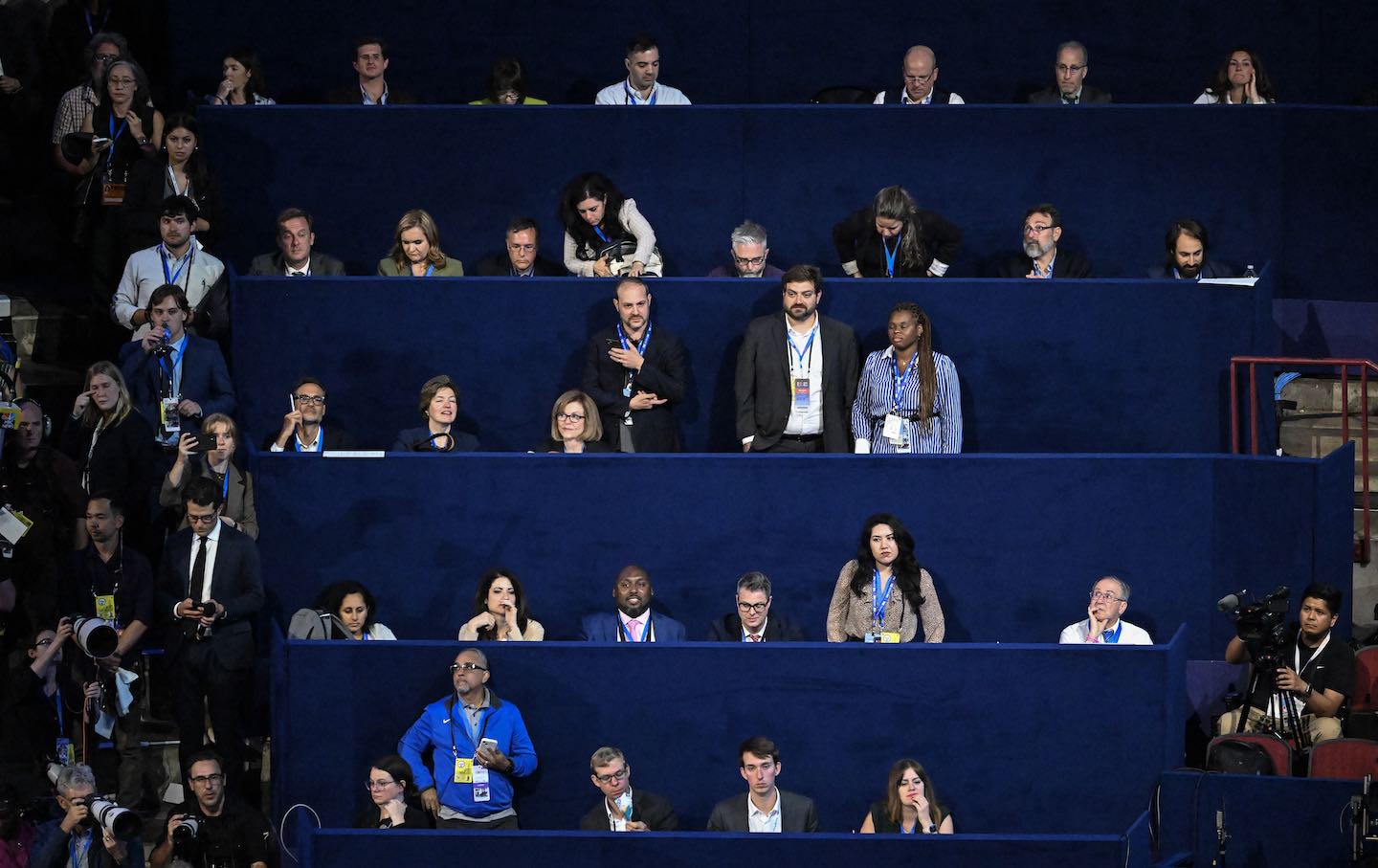 Journalists work on the first day of the Democratic National Convention at the United Center in Chicago on August 19, 2024.