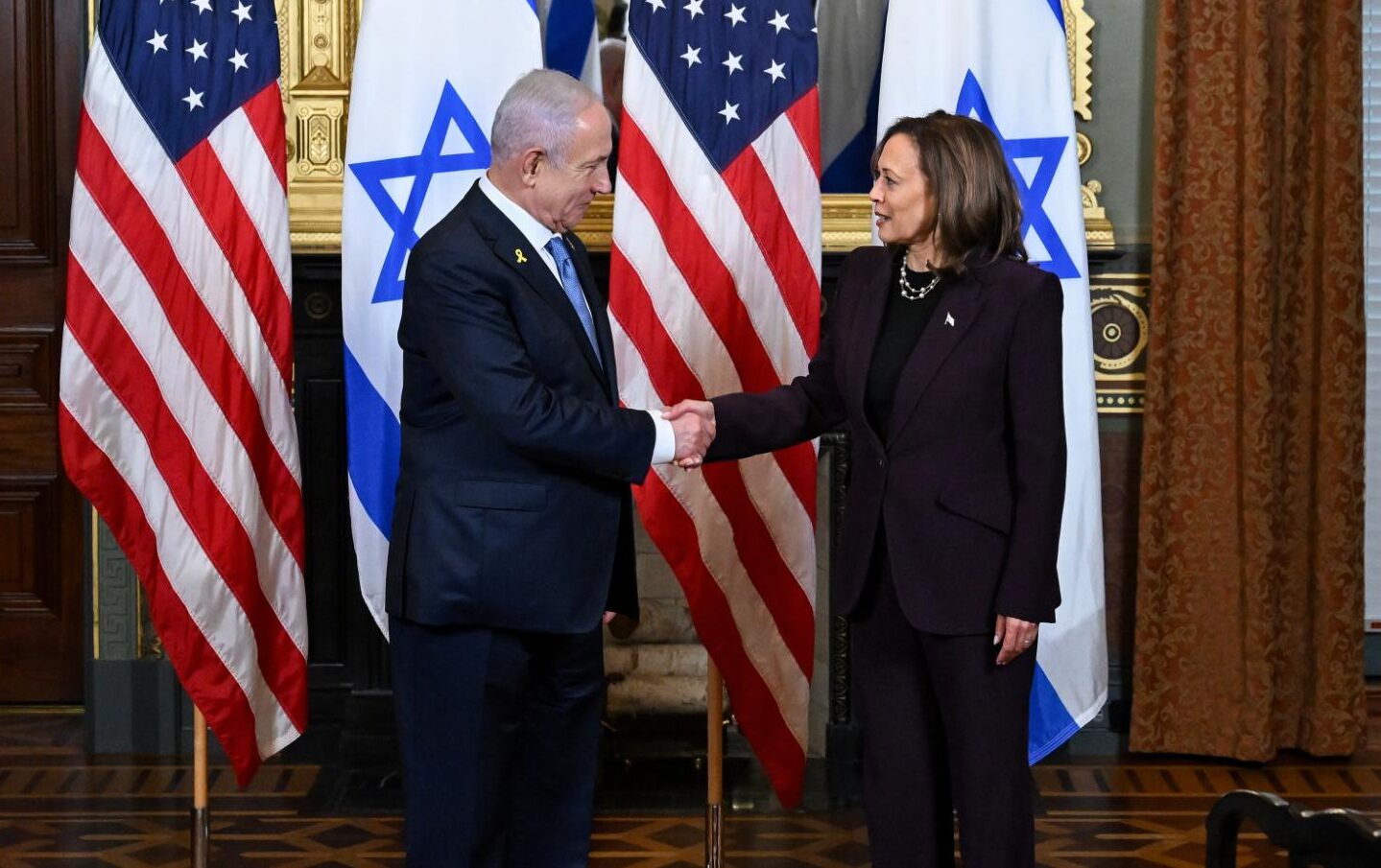 Benjamin Netanyahu, Israel's prime minister, left, and Vice President Kamala Harris shake hands during a meeting in the Vice President's Ceremonial Office in Washington, DC, on July 25, 2024.
