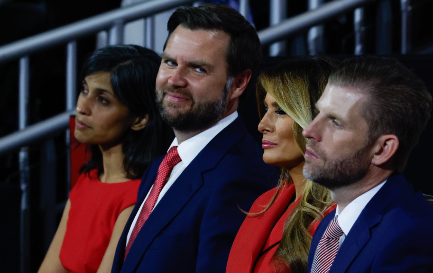 JD Vance smiles looking at Melania and Eric Trump.