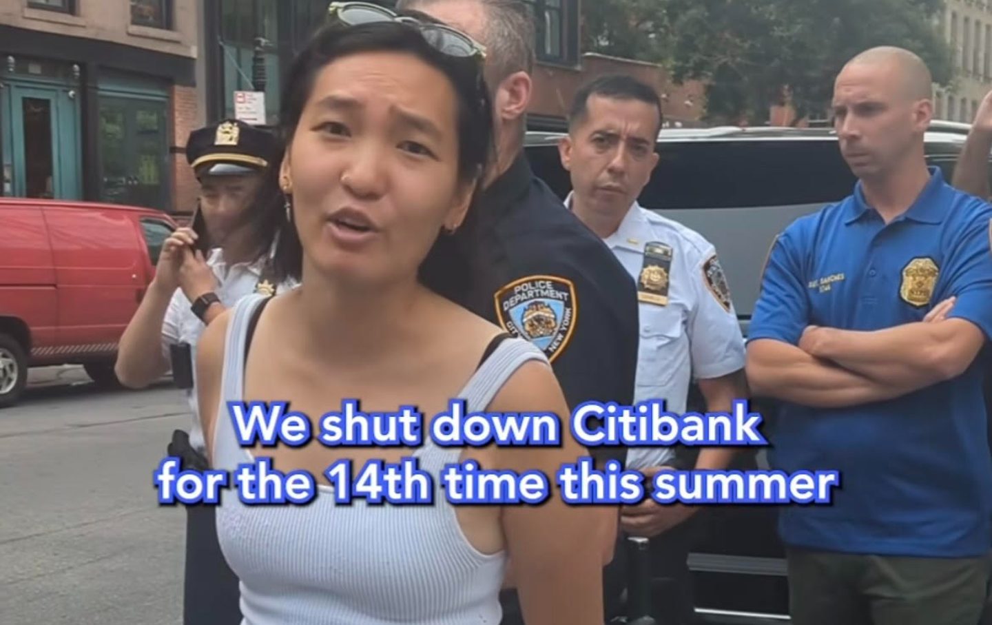 Alice Hu of the Summer of Heat campaign speaks to the camera as she is arrested at Citigroup's Manhattan headquarters on July 22, 2024, in a Stop the Money Pipeline video on Instagram.