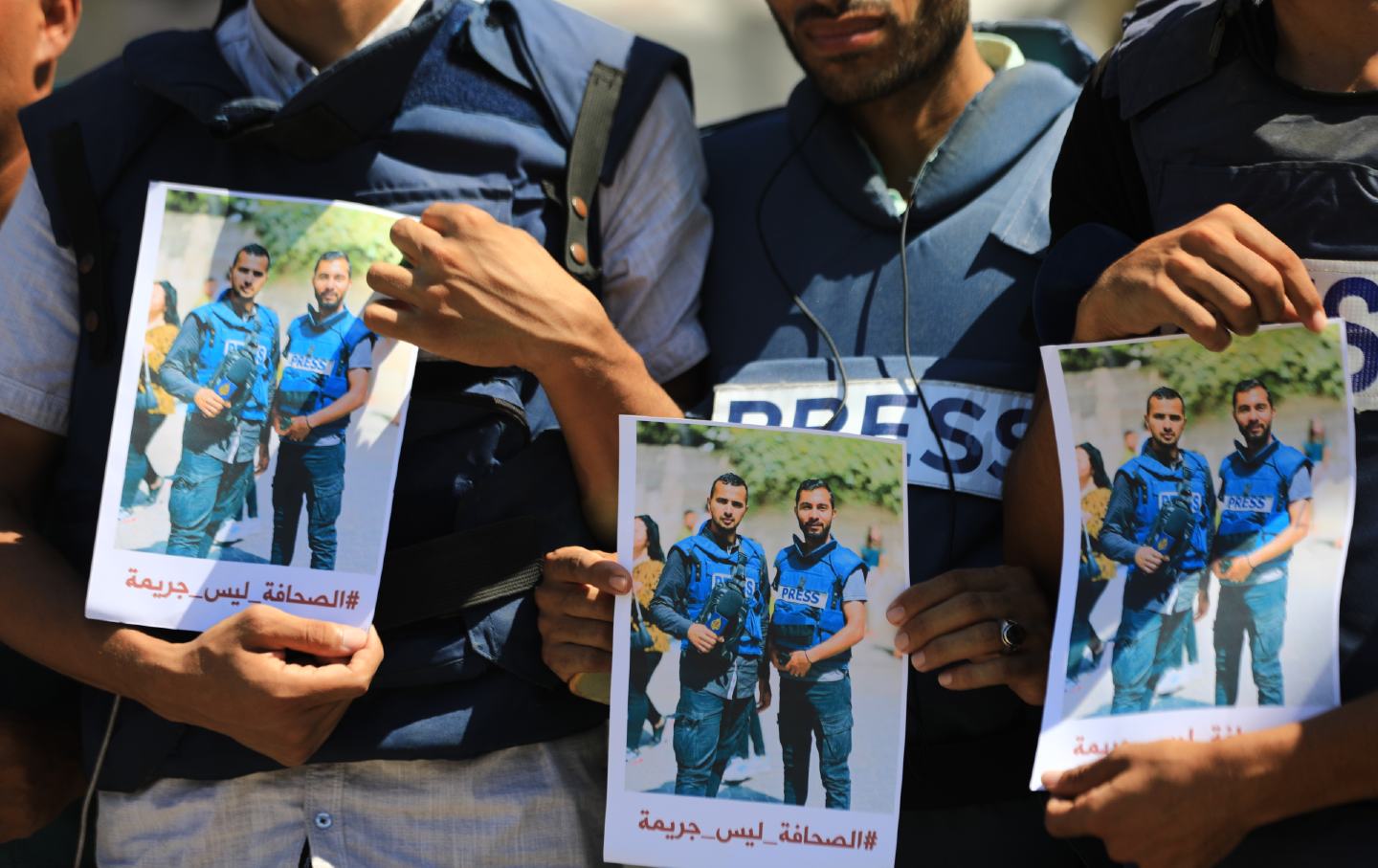 Dozens of journalists protest, holding press badges and pictures of their colleagues Al Jazeera reporter Ismail al-Ghoul and cameraman Rami al-Rifi who lost their lives on duty in Gaza City, Gaza on August 01, 2024.