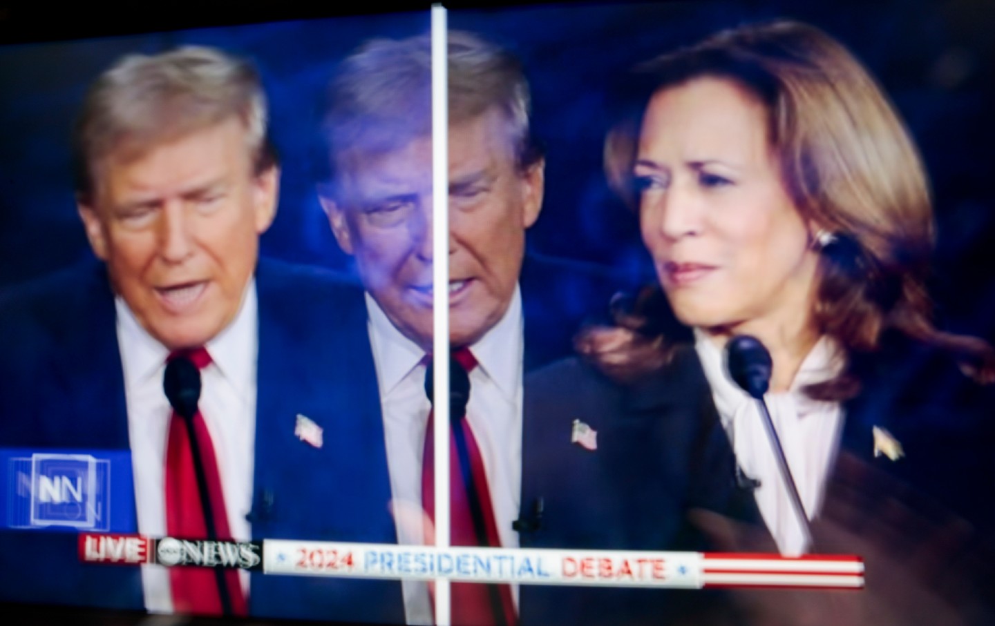 Former US president Donald Trump and US Vice President Kamala Harris are shown on screen in the spin room during the second presidential debate in Philadelphia on September 10, 2024.