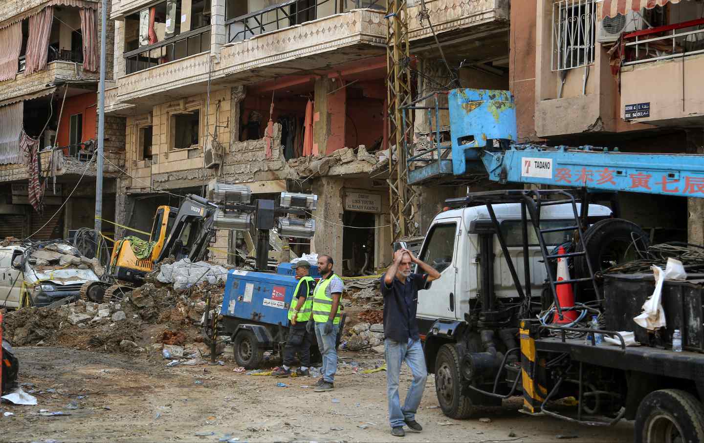 A Lebanese man reacts to the destruction after an Israeli air raid attack in Beirut's southern suburbs.