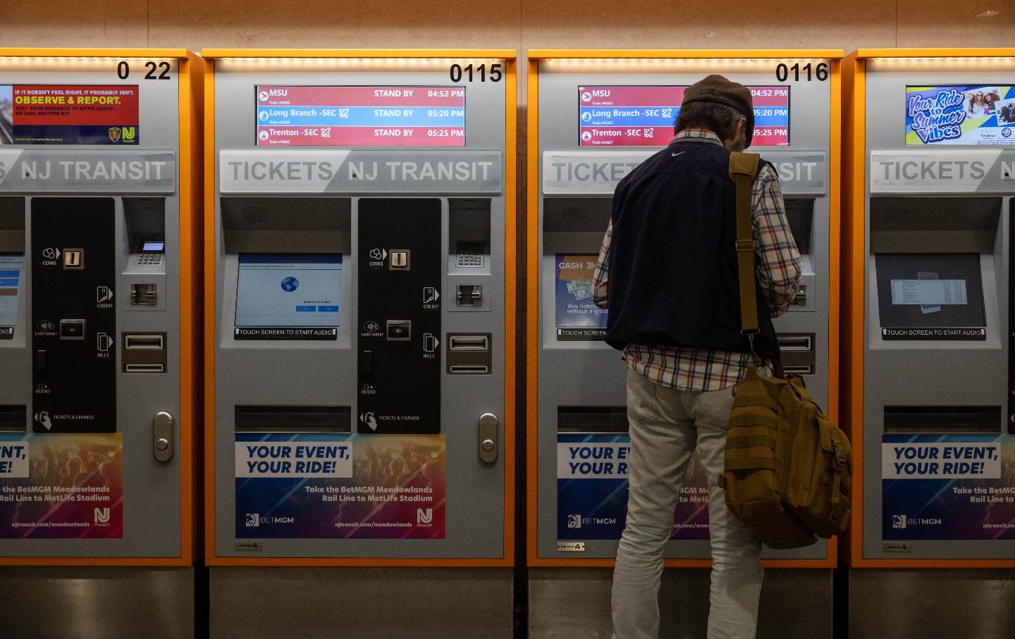 A commuter at a ticket kiosk at New Jersey Transit train station at Penn Station in New York.