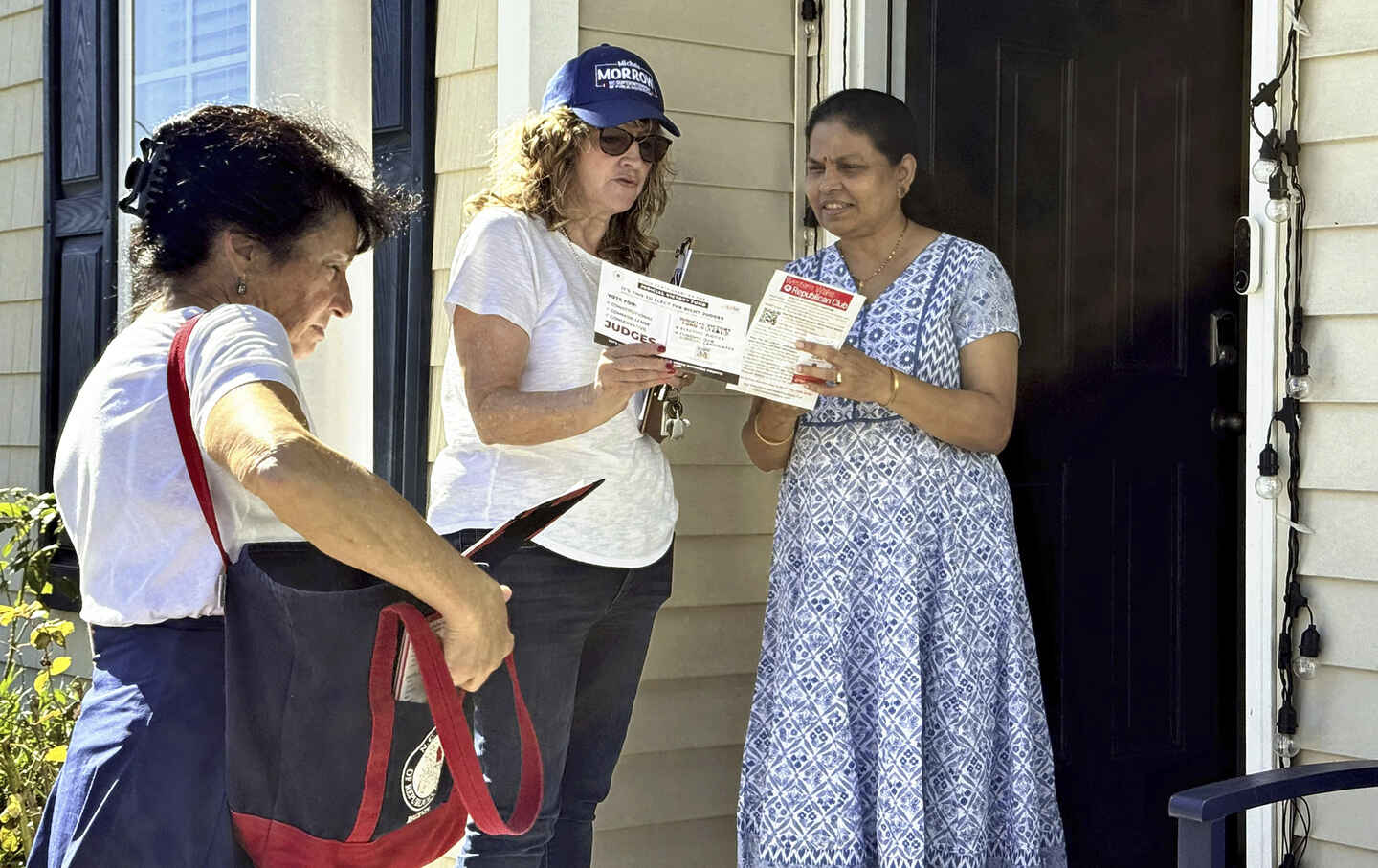 Women go door-to-door canvassing, calling for voting for Donald Trump in the suburbs of Raleigh, North Carolina, on October 12, 2024.