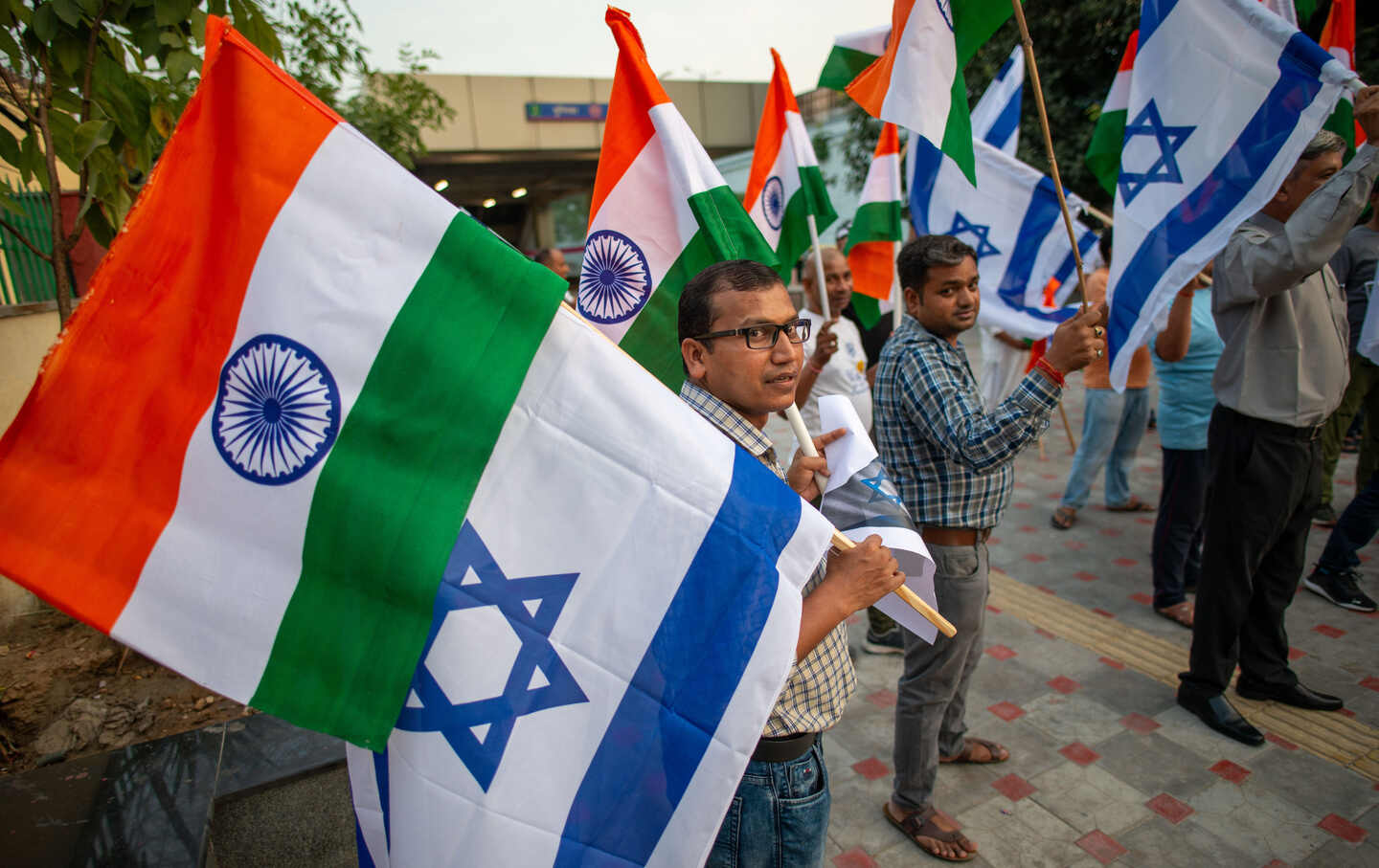 Supporter of India’s ruling Bharatiya Janata Party holding flags expressing their opinions during a protest to show solidarity with Israel.