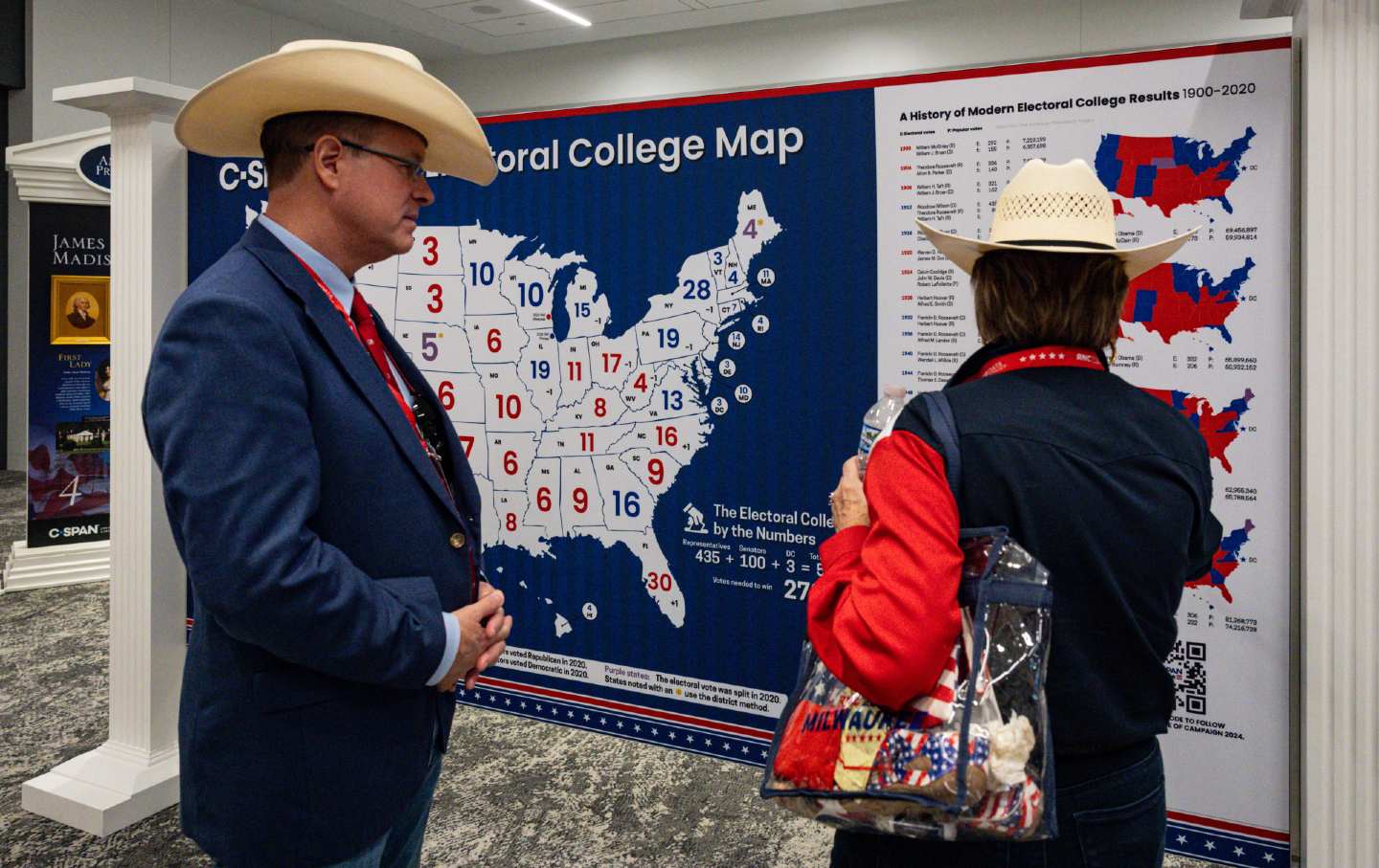 Attendees at the 2024 Republican National Convention look at a map of the US Electoral College.