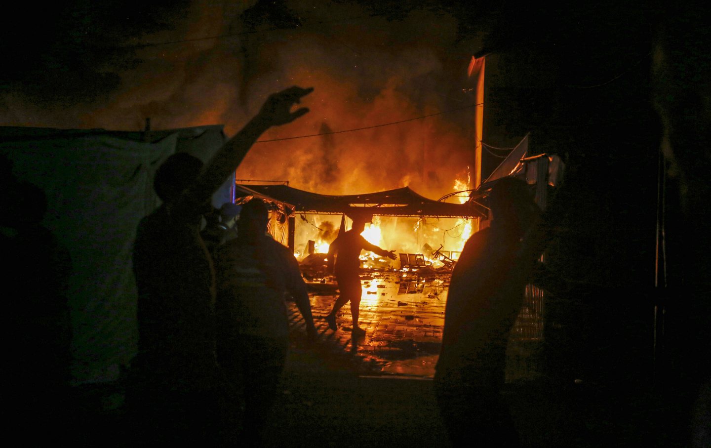 Fire breaks out on the tents of displaced Palestinians after Israeli attacks in the garden of Al-Aqsa Martyrs Hospital in Gaza City, Gaza on October 14, 2024.