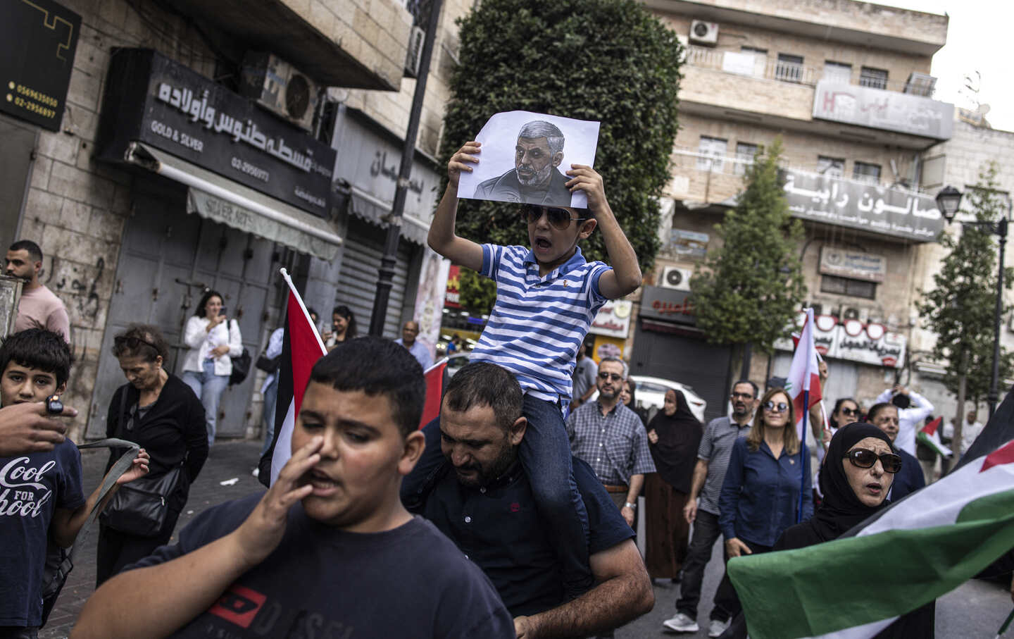 A young Palestinian boy holds up a portrait of slain Hamas leader Yahya Sinwar during a rally in Ramallah, in the Occupie-West Bank, on October 18, 2024.