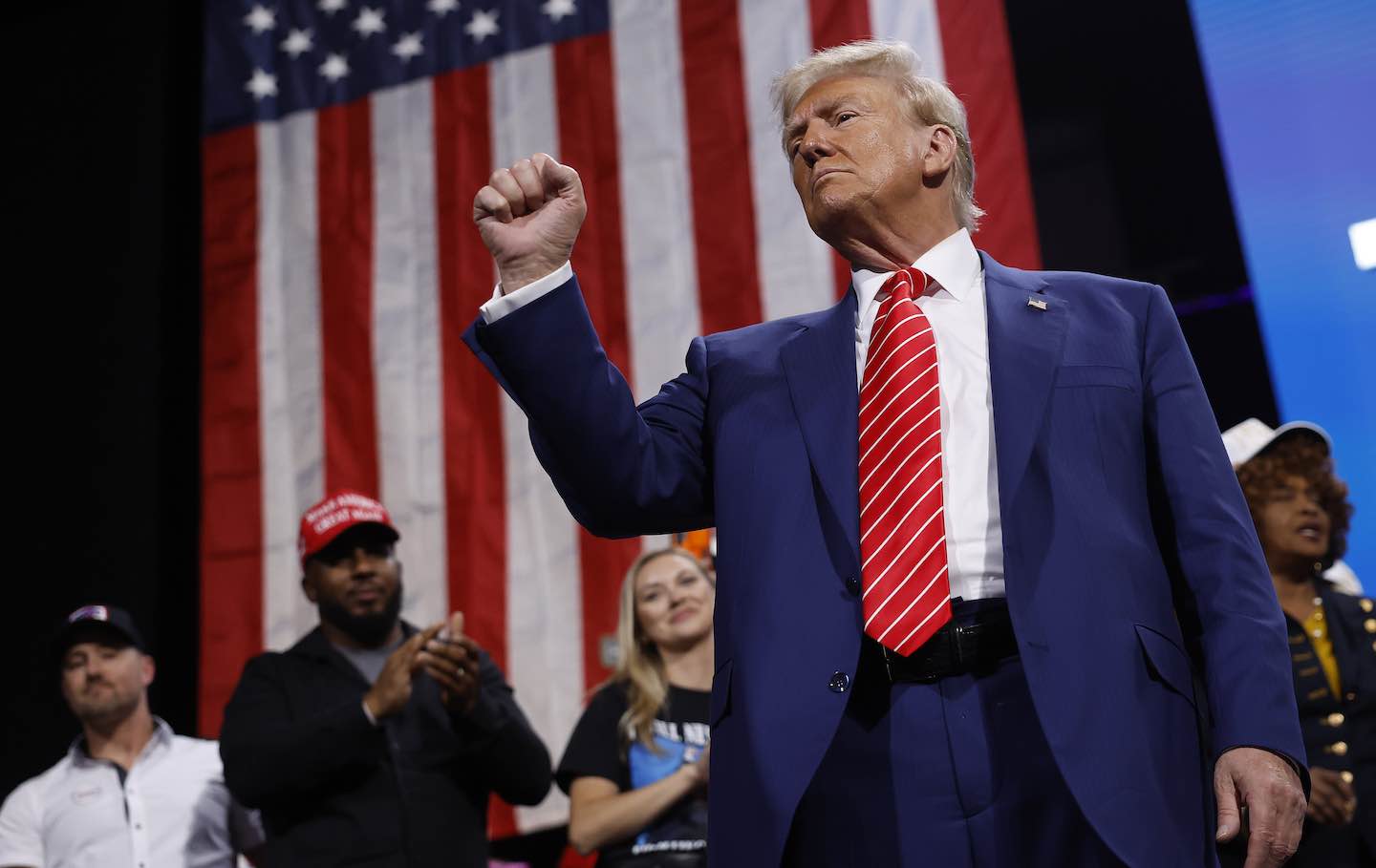 Republican presidential nominee Donald Trump raises his fist after delivering remarks during a campaign rally at the Cobb Energy Performing Arts Centre on October 15, 2024, in Atlanta, Georgia.