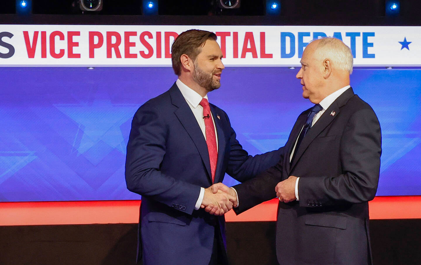 Republican vice presidential candidate Senator JD Vance (R-OH) and Democratic vice presidential candidate Minnesota Governor Tim Walz greet each other ahead of a debate at the CBS Broadcast Center on October 1, 2024, in New York City.