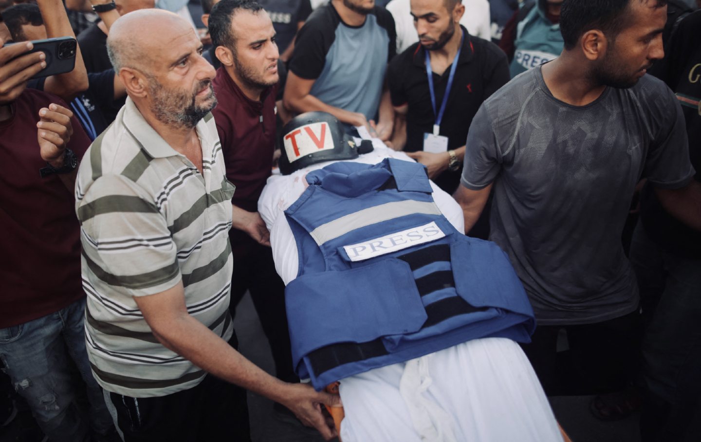 Friends and relatives carry the body of Hamas-run Al-Aqsa TV cameraman Muhammad al-Tanani, who was killed by the Israeli army, in Gaza City on October 9, 2024