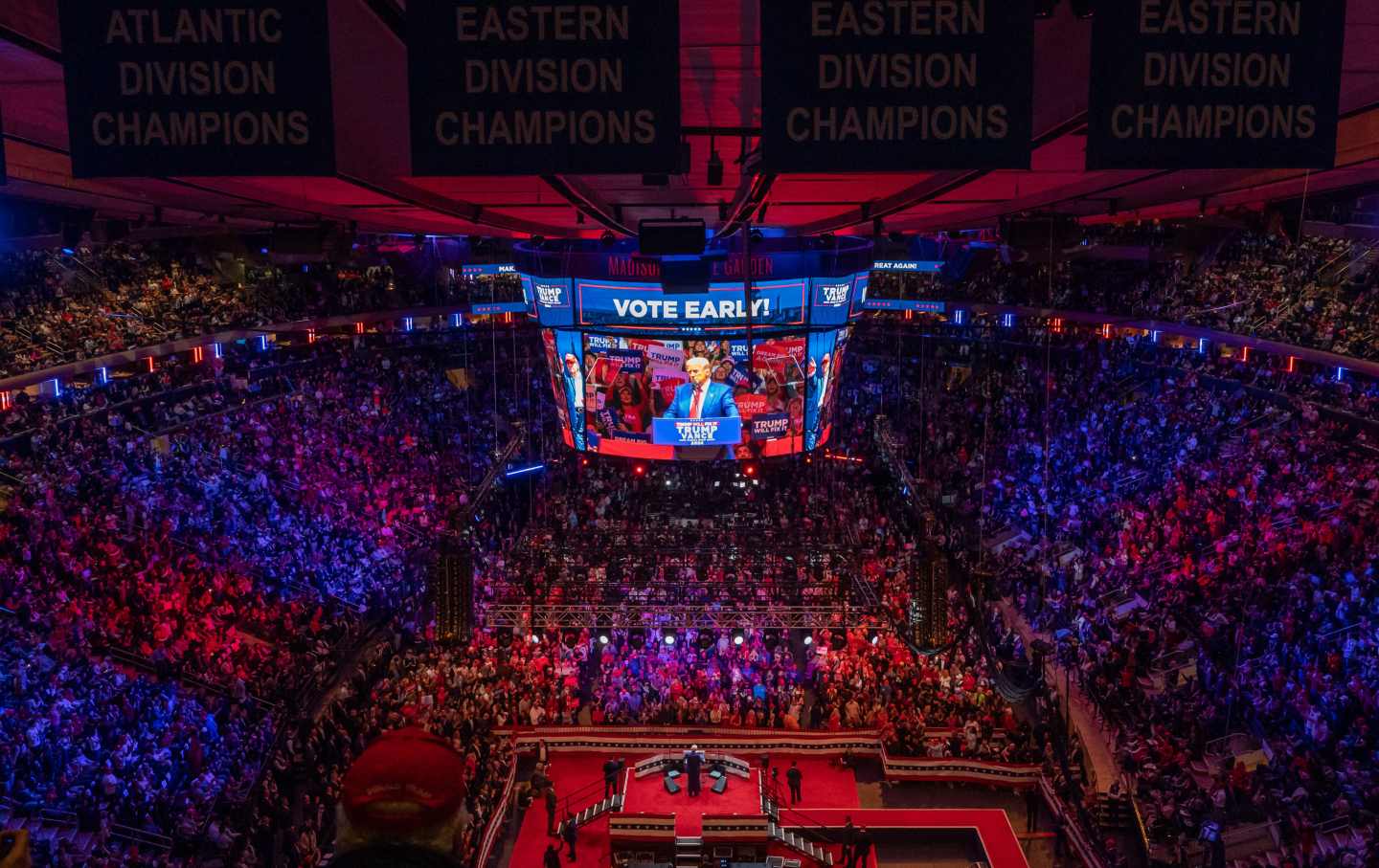 Trump addresses a crowd on a large screen in the packed Madison Square Garden.