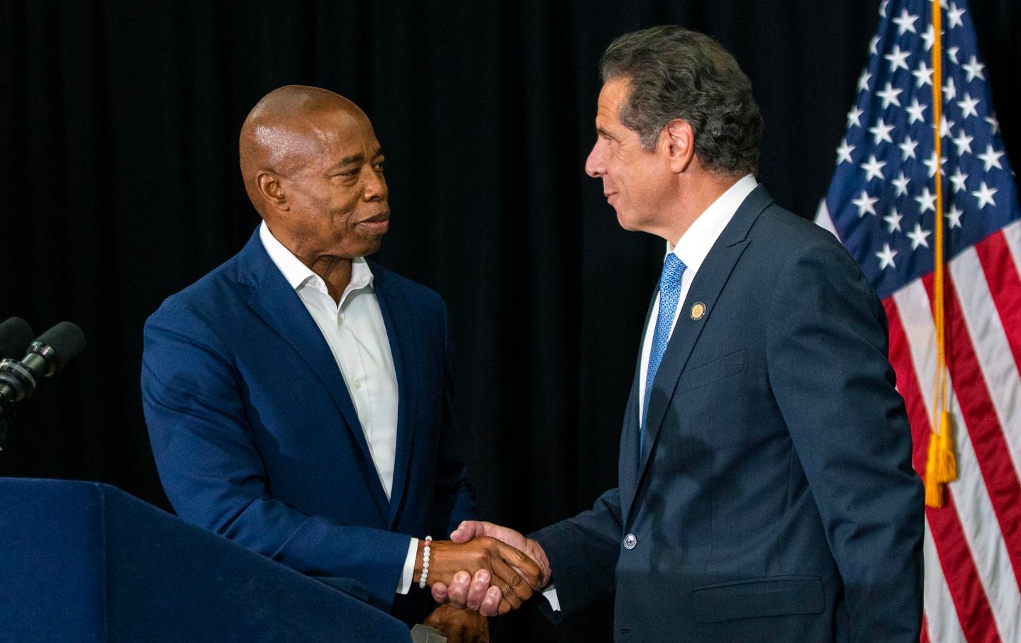 Eric Adams and New York Gov. Andrew Cuomo shake hands during a press conference, July 14, 2021, in Brooklyn, NY.