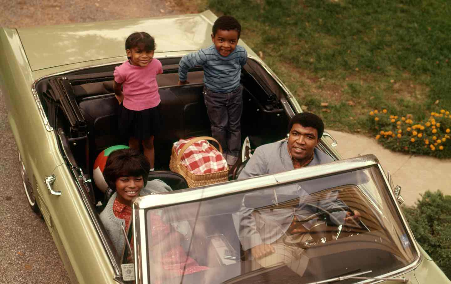 An African American family seated in a convertible, 1972.