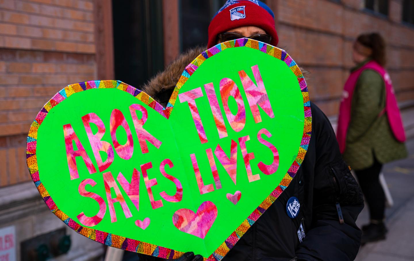 A protester holds a sign reading 