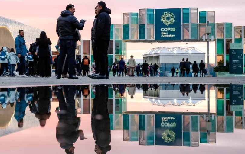 Participants walk and network in front of the main entrance during the United Nations Climate Change Conference COP29 at Baku Olympic Stadium in Baku, Azerbaijan, on November 14.