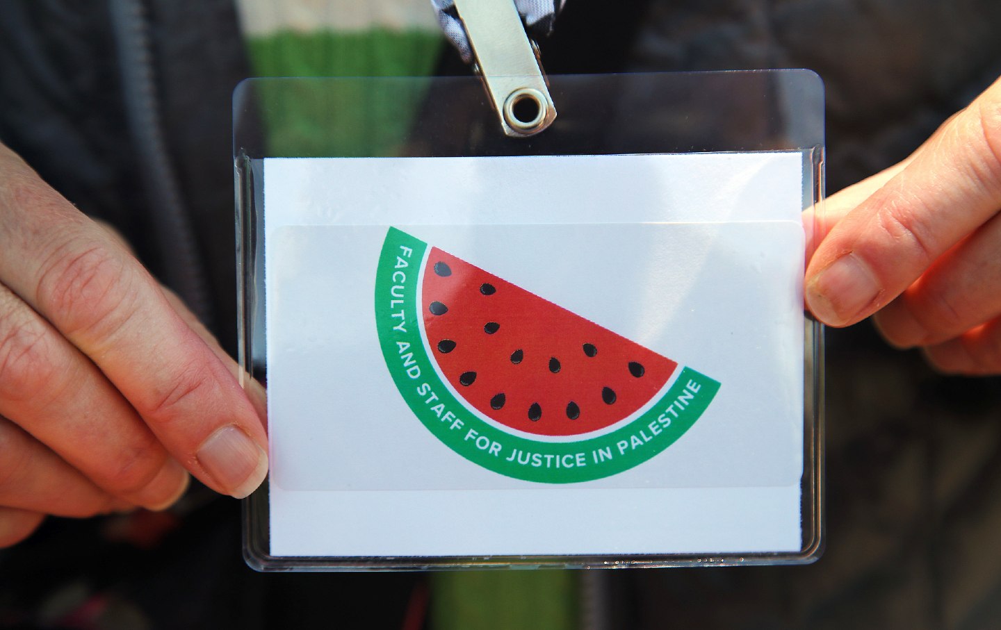 A Harvard faculty member wears a watermelon pin, a pro-Palestinian symbol, in Cambridge, Massachusetts, on May 10, 2024.