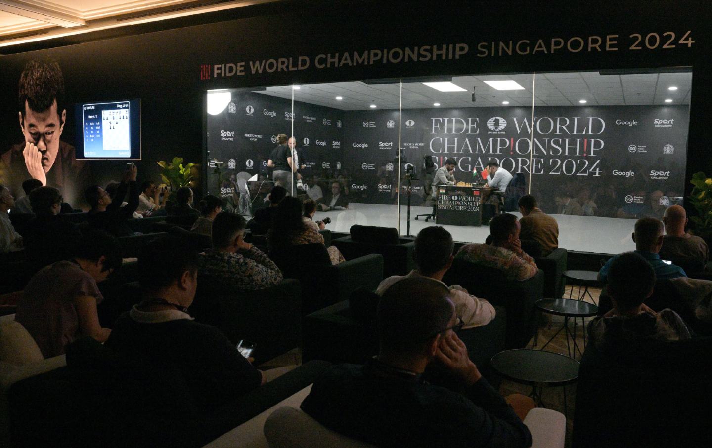 Ding Liren (top right) and Gukesh Donmaraj (top left) are seen during the first match of the FIDE World Chess Championship 2024 in Singapore on November 25, 2024.