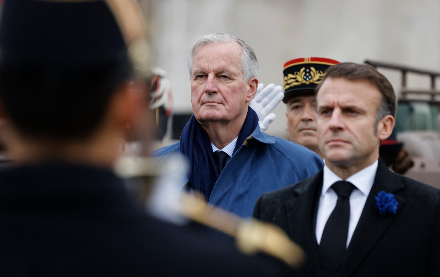 French President Emmanuel Macron and Prime Minister Michel Barnier stand at attention during commemorations marking the 106th anniversary of the armistice ending World War I on November 11, 2024.