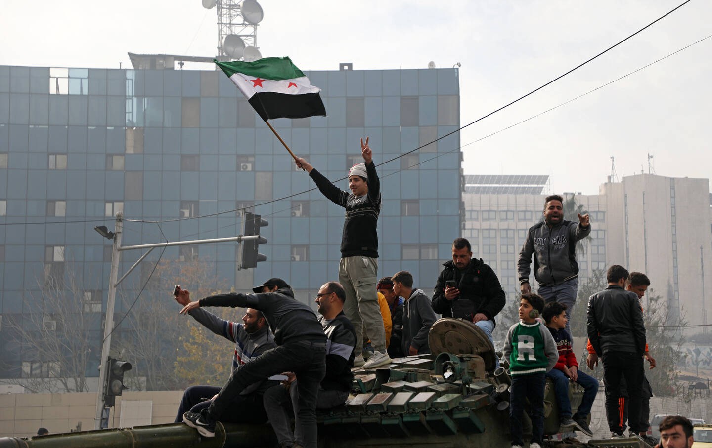 People react to the fall of Syrian regime in Umayyad Square on December 8, 2024, in Damascus, Syria.