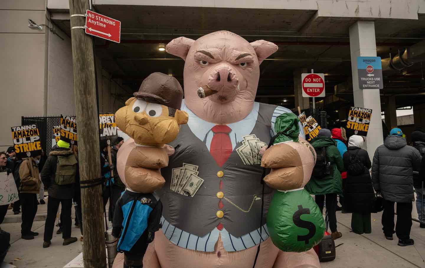 An inflatable pig stands alongside Amazon workers and union members who picketed outside the DB4 Amazon distribution center in the Queens borough of New York City, on December 20, 2024.